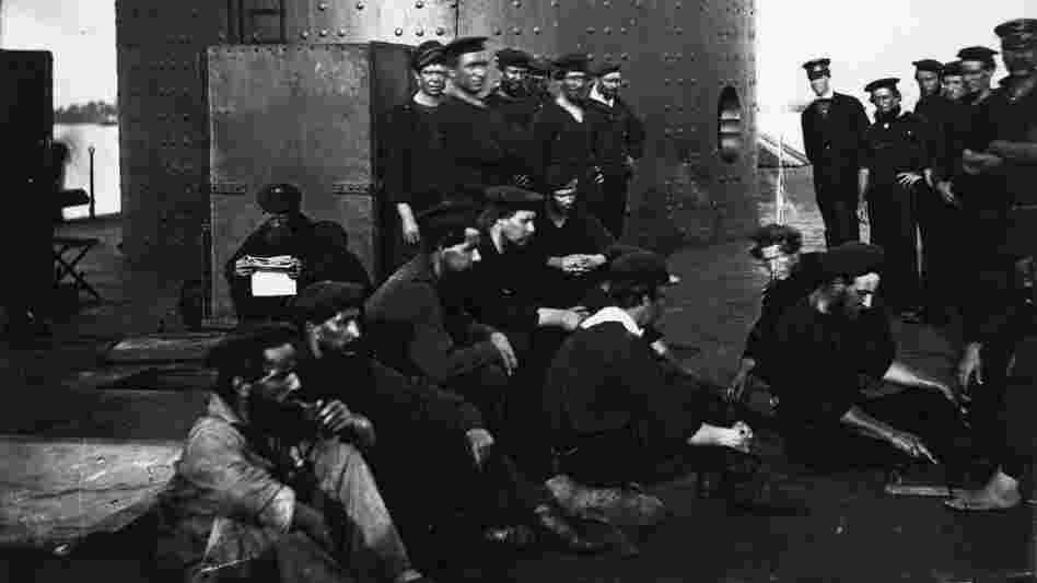 In this undated photograph provided by Naval History and Heritage Command, the crew of USS Monitor relax just outside of its turret.