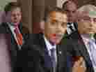Jim Messina (left), the head of Organizing for Action and a former top Obama campaign and White House aide, watches President Obama make a statement in the White House Cabinet Room in 2010.