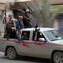Syrian rebels celebrate in a street in the northeastern Syrian city of Raqqah after capturing the provincial capital on March 4. The government has responded with air strikes, creating a new wave of refugees.