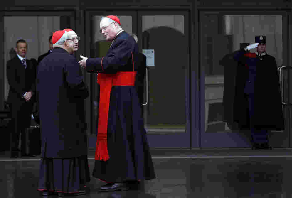 U.S. Cardinal Timothy Dolan (right) chats with other cardinals as they arrive for a meeting at the Synod Hall in the Vatican on Thursday.