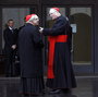 U.S. Cardinal Timothy Dolan (right) chats with other cardinals as they arrive for a meeting at the Synod Hall in the Vatican on Thursday.