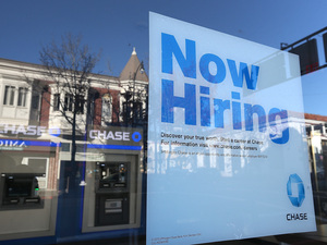 The job market showed strong growth in February. But questions about low wages, consumer debt and government austerity cloud the sunny picture.