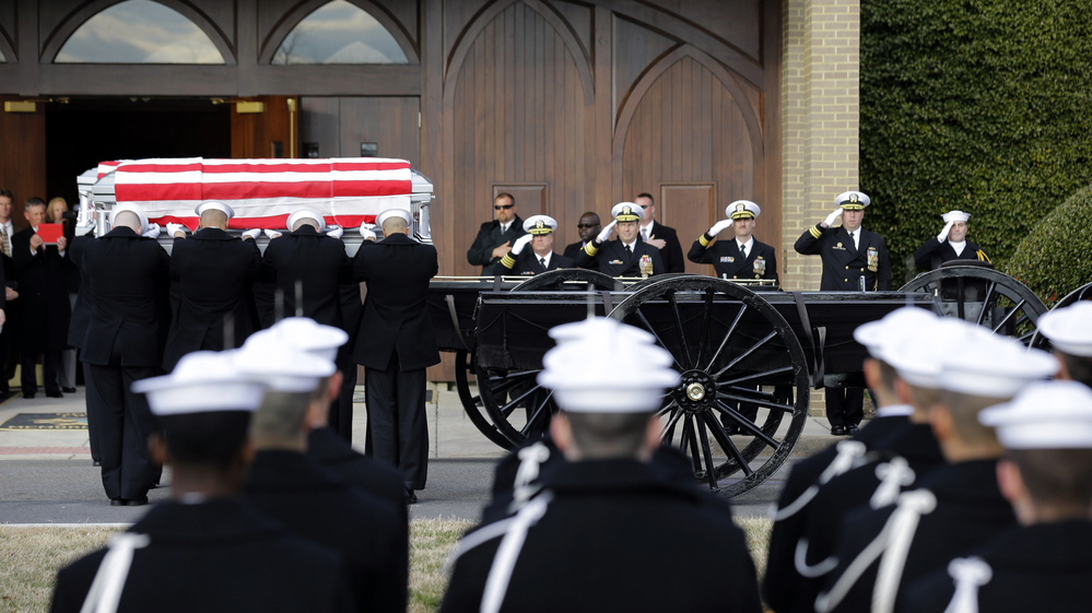 Navy honor guard teams participate in services to honor two sailors from the Civil War ship the USS Monitor on Friday in Arlington, Va.