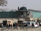 Afghanistan National Army soldiers and security personnel walk at the site of a suicide attack next to the Ministry of Defense main gate in Kabul on Saturday. Afghanistan National Army soldiers and security personnel walk at the site of a suicide attack next to the Ministry of Defense main gate in Kabul on Saturday.