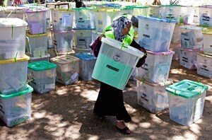 An Independent Electoral and Boundaries Commission official carries closed ballot boxes to be counted in Mombasa.