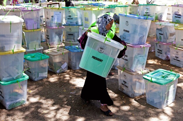 An Independent Electoral and Boundaries Commission official carries closed ballot boxes to be counted in Mombasa.