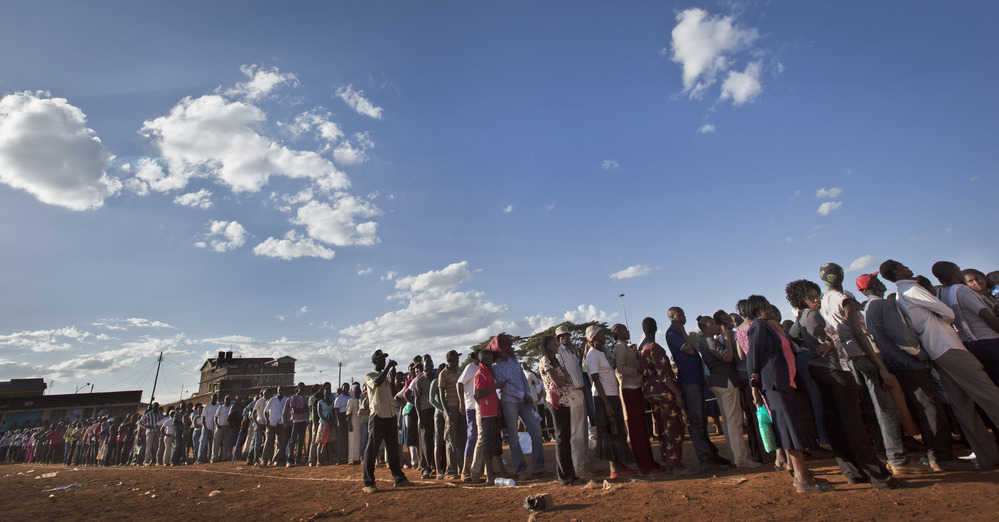 Voters queued for hours across Kenya as old-fashioned paper ballots had to be rushed to polling stations.