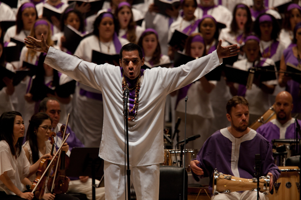 With his <em>St. Mark Passion,</em> composer Osvaldo Golijov turns the traditional Passion (like those of J.S. Bach) on its head and gives it a spin or two. Here, Javier Silva performs in front of the Forest Hills High School Concert Choir, the Frank Sinatra School of the Arts Concert Choir and Songs of Solomon at Carnegie Hall.