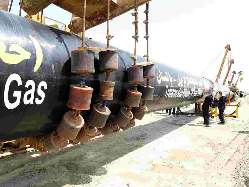 Iranians work on a section of the pipeline on Monday.