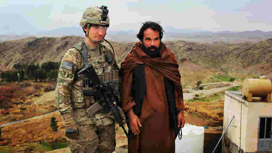 The U.S. military is increasingly focused on helping the Afghan government and security forces become self-sufficient. Here, U.S. Army 1st Lt. Phillip Baki visits with an Afghan police officer, Abdul Karim, at a checkpoint overlooking the Dahla Dam in the southern province of Kandahar.