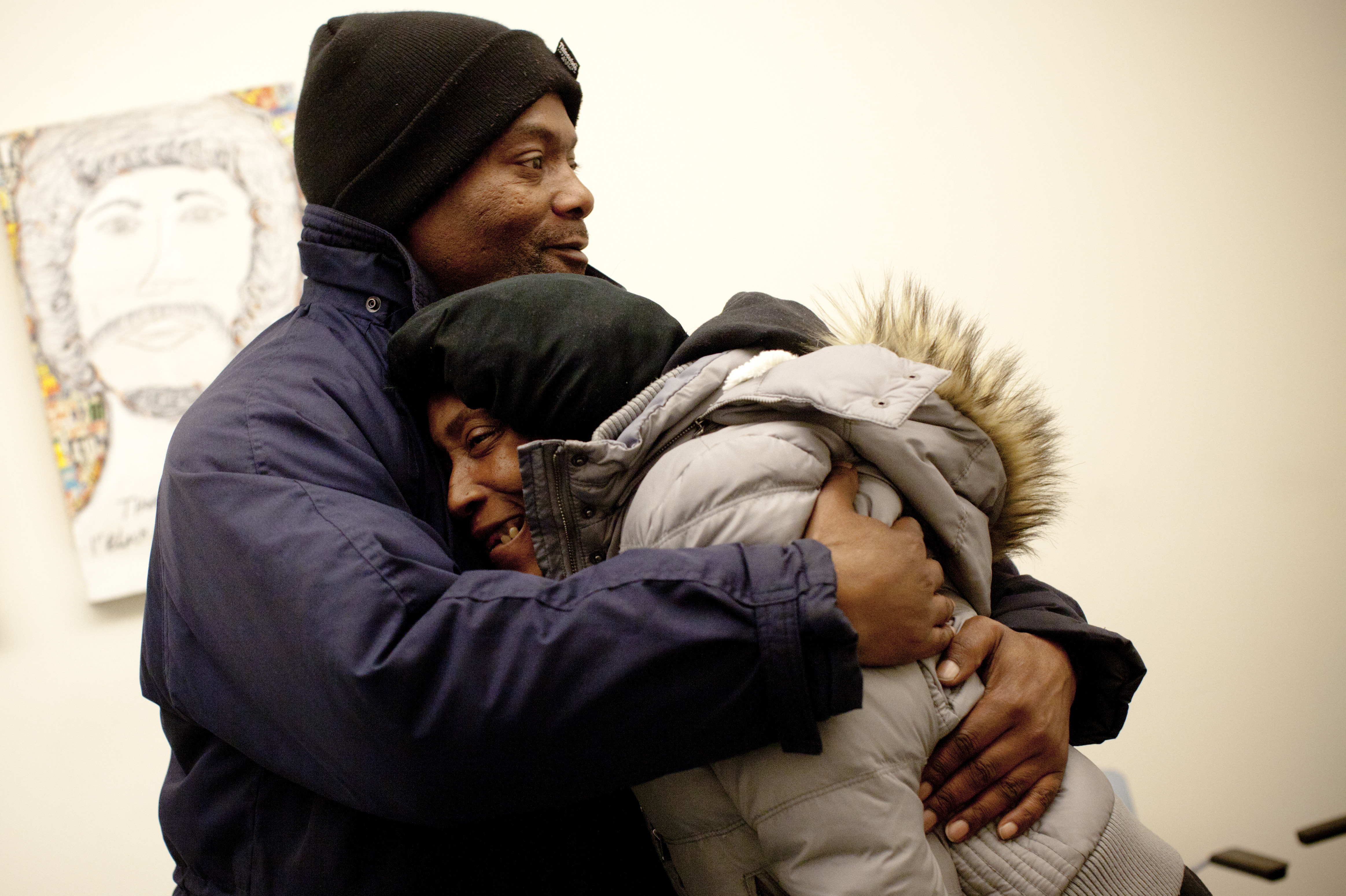 Simmons hugs Evelyn inside HCH. He has been trying to help the Hearnes and many others get off the streets.