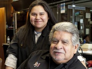 Richard Piña and his youngest daughter, Alex, both work at Rich's Den in Calumet City, Ill. Pina bought the barbershop a few years before he retired from the Chicago police force.
