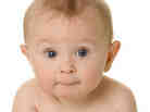 A baby sitting and looking at the camera A baby sitting and looking at the camera
