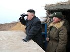 In this image released by North Korea's Central News Agency, leader Kim Jong Un is said to be using a pair of binoculars to look south during an inspection of a  front-line army unit.