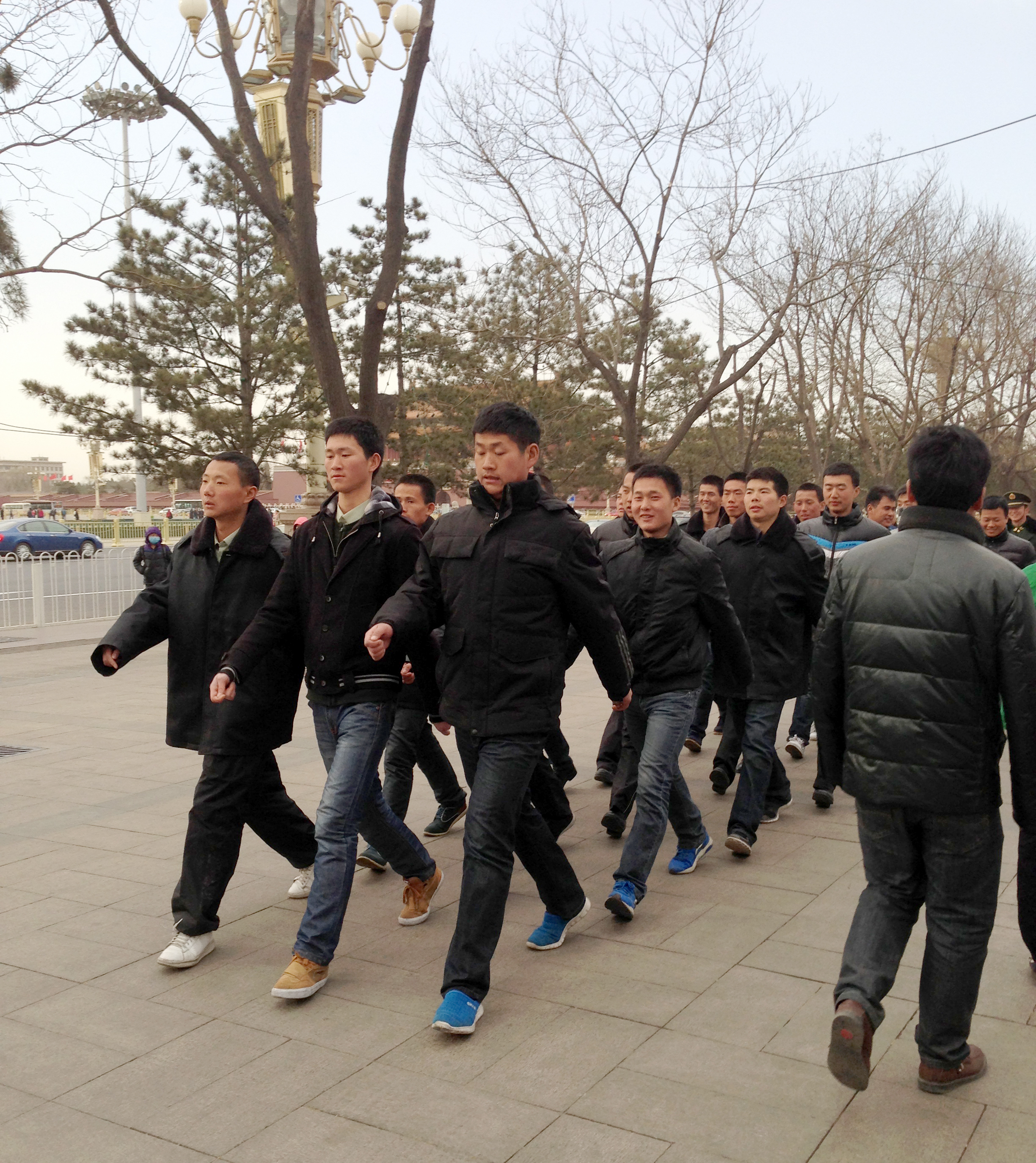 Just another day in Beijing: Plainclothes policemen make the rounds near Tiananmen Square, where the annual meeting of the country's National People's Congress is under way.