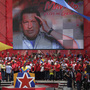 An image of late President Hugo Chavez hangs behind acting President Nicolas Maduro, as he speaks to supporters after registering his candidacy outside the national electoral council in Caracas, Venezuela, on Monday. An image of late President Hugo Chavez hangs behind acting President Nicolas Maduro, as he speaks to supporters after registering his candidacy outside the national electoral council in Caracas, Venezuela, on Monday.