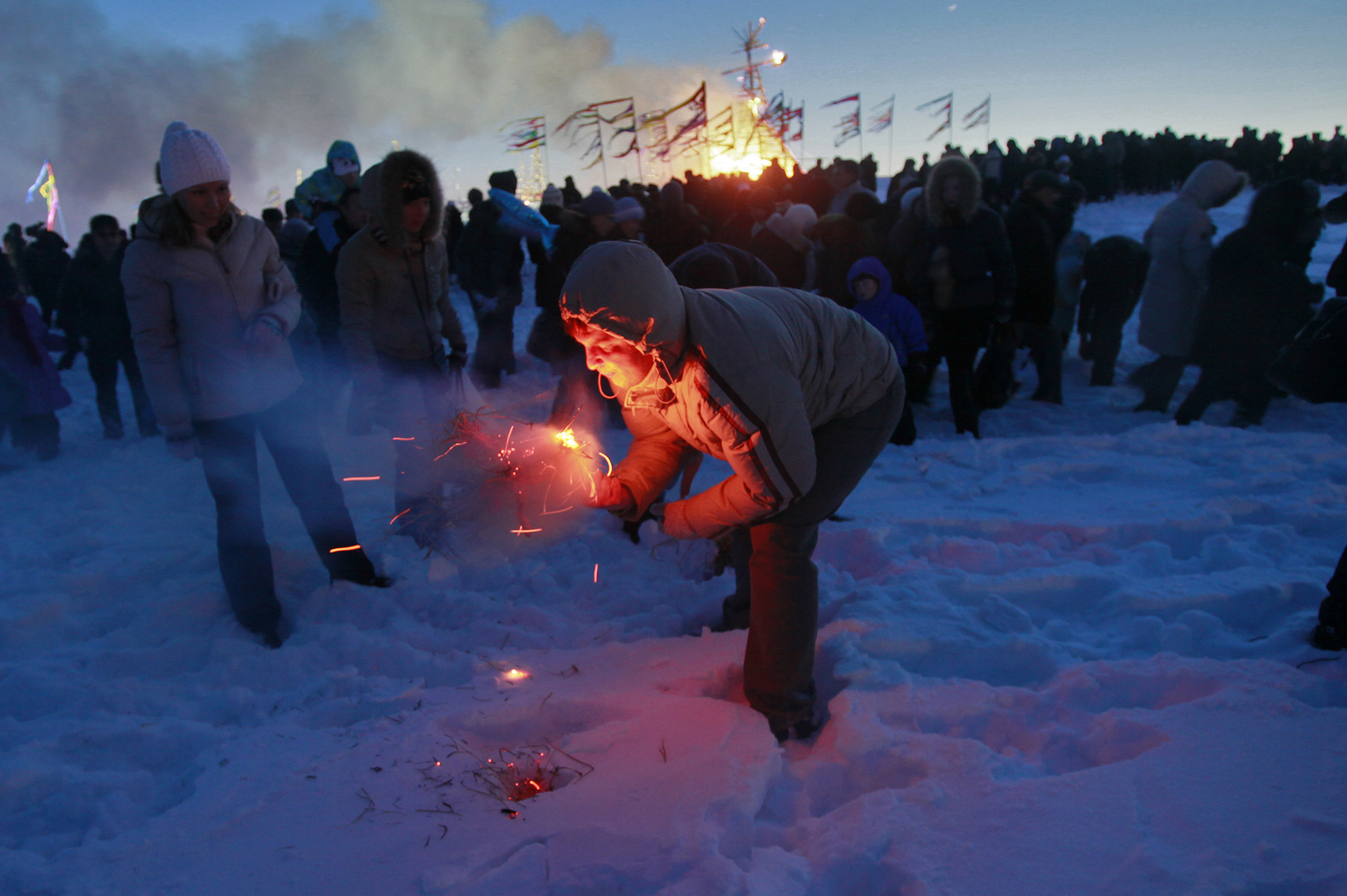 A man tries to burn a small effigy of Lady Maslenitsa during the final evening of festivities in 2011 in St. Petersburg, Russia. The torching marks the end of the holiday — a fiery goodbye to 
