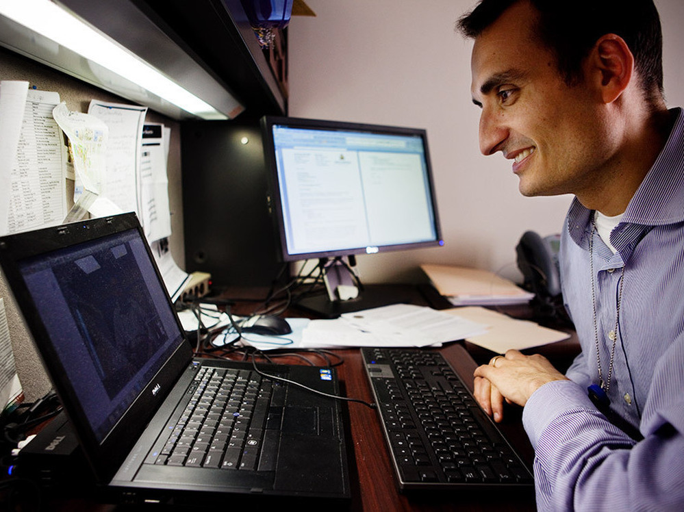 Dr. Ray Dorsey video chats with a patient in New York State from his office at Johns Hopkins Medical Center in Baltimore in 2011.