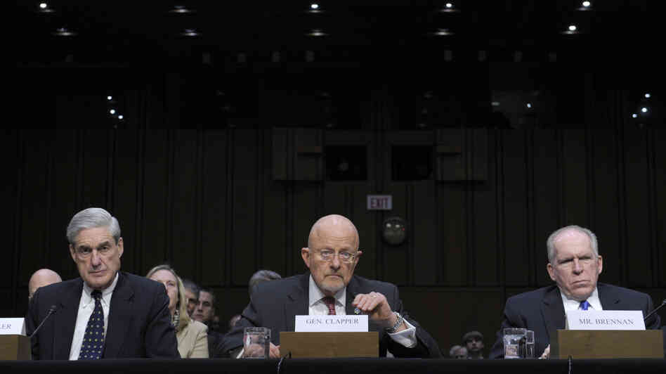 Director of National Intelligence James Clapper (center), accompanied by FBI Director Robert Mueller (left) and CIA Director John Brennan, testifies on Capitol Hill on Tuesday.