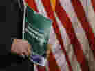 A member of the House Budget Committee holds a copy of the Republican budget proposal on Tuesday in Washington.