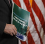 A member of the House Budget Committee holds a copy of the Republican budget proposal on Tuesday in Washington.