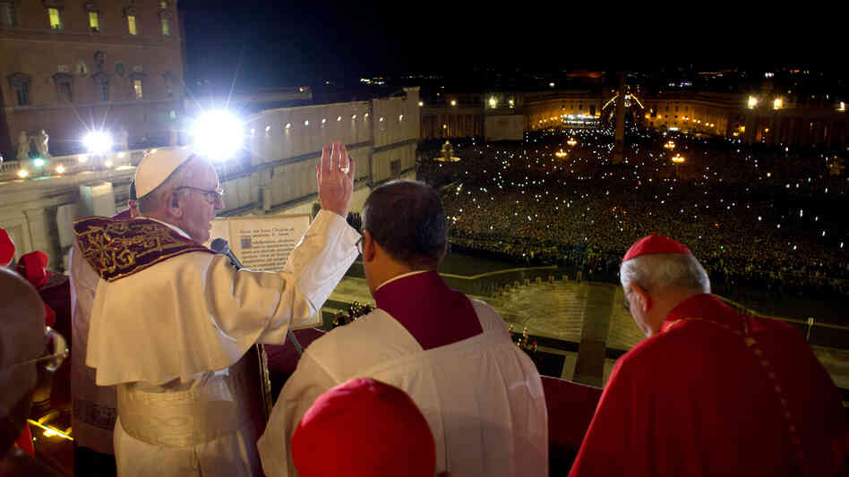 The newly elected Pope Francis  appears on the main balcony of St Peter's Basilica. His name was chosen after St. Francis of Assisi, the Vatican says.