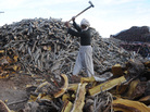 An Afghan laborer works in a firewood yard at a market in Herat on Dec. 11, 2011. An Afghan laborer works in a firewood yard at a market in Herat on Dec. 11, 2011.