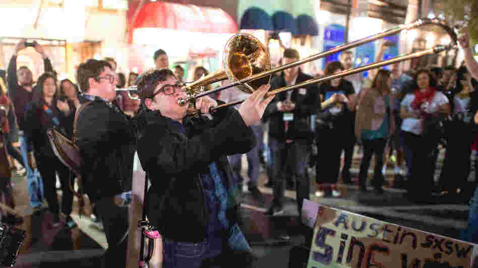 Twin Horns Of Joy? Members of the band The Bottom Dollars play on the street in Austin, Texas, during the opening night of the South by Southwest music festival.