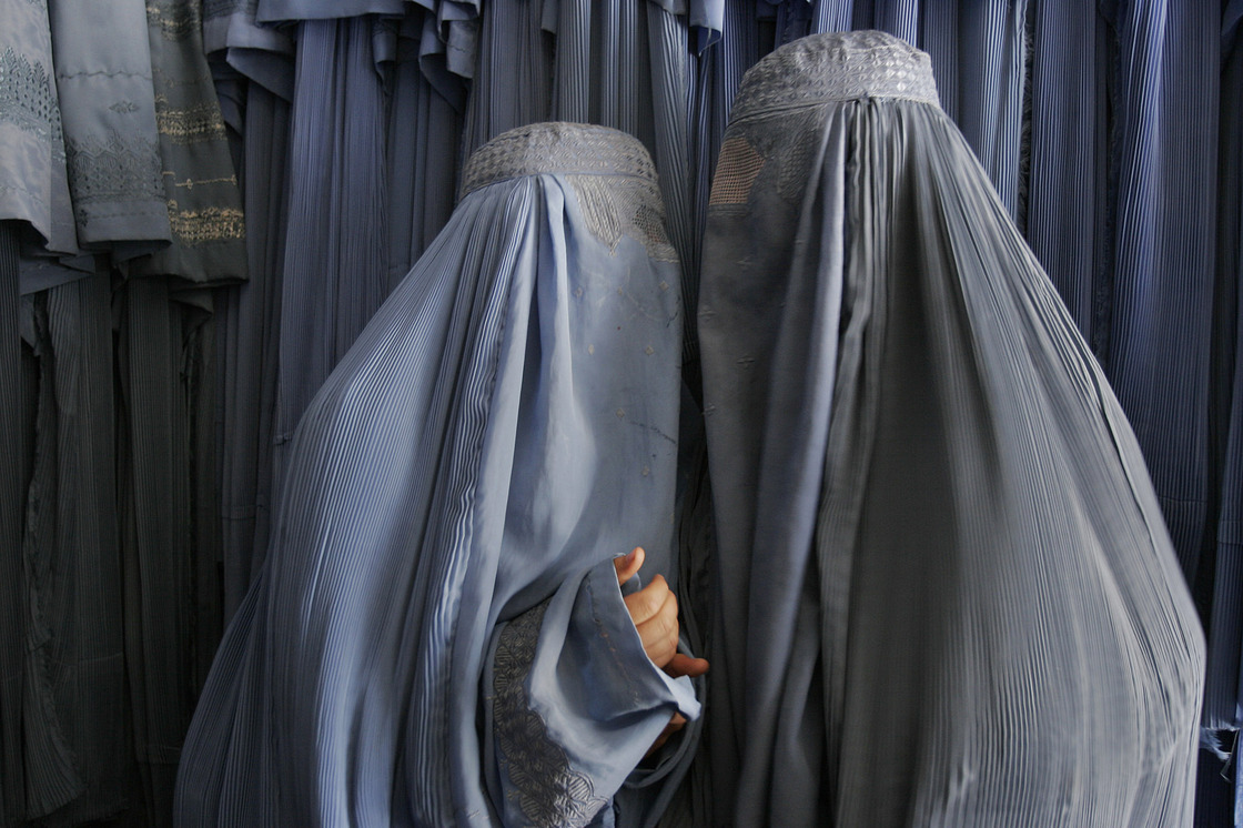 Two Afghan women clad in burqas whisper in a shop in Kabul, 2007. Despite advances in women's rights since the fall of the Taliban, most Afghan women, especially outside the capital, still opt for the all-enveloping cloak. Two Afghan women clad in burqas whisper in a shop in Kabul, 2007. Despite advances in women's rights since the fall of the Taliban, most Afghan women, especially outside the capital, still opt for the all-enveloping cloak.
