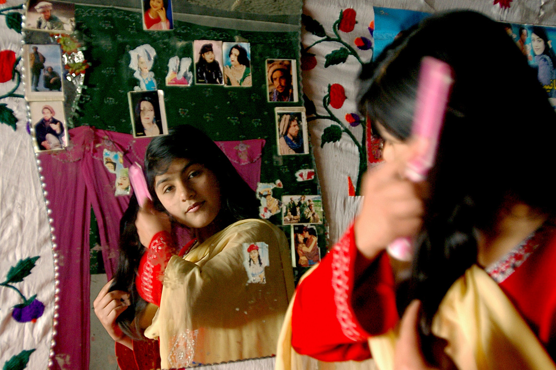 An Afghan girl brushes her hair in Kabul, 2007. An Afghan girl brushes her hair in Kabul, 2007.