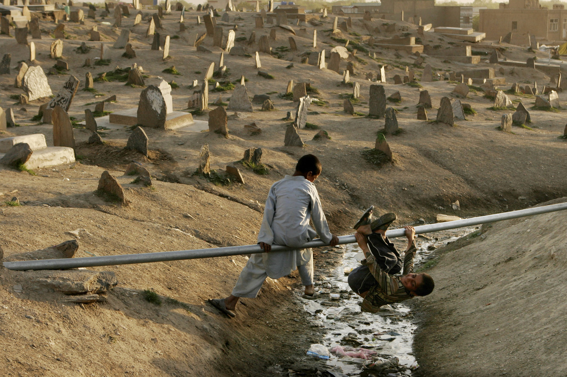 Boys play on a water pipe in a cemetery in Kabul, 2007. Boys play on a water pipe in a cemetery in Kabul, 2007.