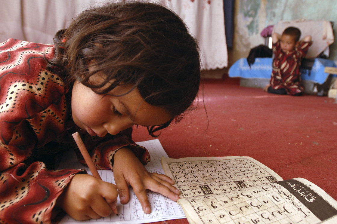 Laila, 7, works on homework in her home in Kabul, 2008. Laila, 7, works on homework in her home in Kabul, 2008.