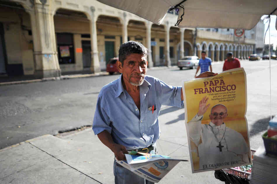 A man in San Salvador sells a newspaper with the announcement of the election of Argentina's cardinal Jorge Mario Bergoglio as the new Pope Francis. A man in San Salvador sells a newspaper with the announcement of the election of Argentina's cardinal Jorge Mario Bergoglio as the new Pope Francis.