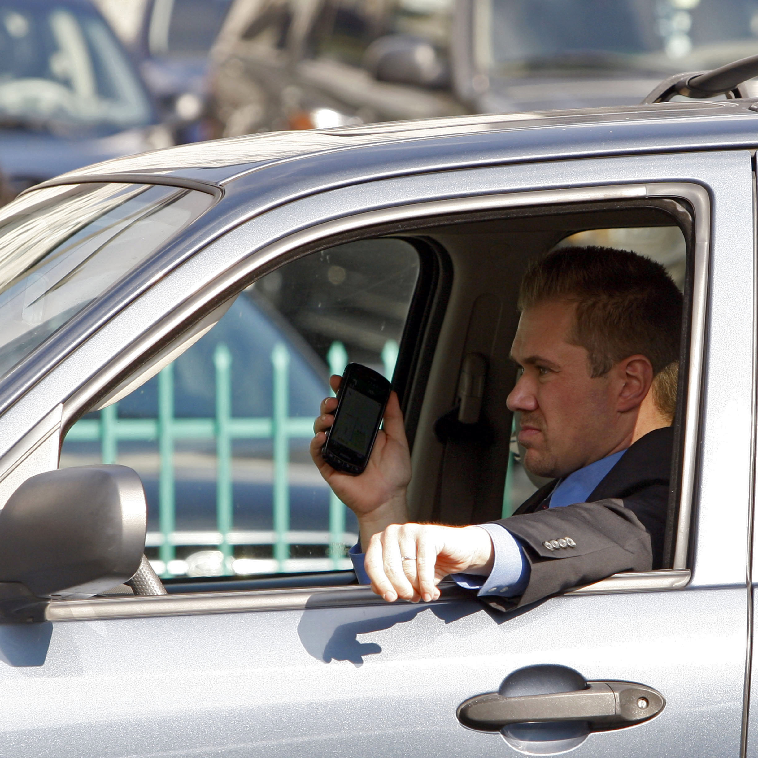 A driver uses a cellphone while driving Wednesday, Dec. 14, 2011, downtown Los Angeles.