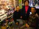 Wan Joon Kim (right), with his son Kirk and wife, Boo Ja, at their stall inside the Compton Swap Meet last January.