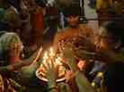 Sri Lankan Hindus receive blessings from a priest holding an oil lamp during the Maha Shivaratri festival at a temple in Colombo on March 10, 2013. Sri Lankan Hindus receive blessings from a priest holding an oil lamp during the Maha Shivaratri festival at a temple in Colombo on March 10, 2013.