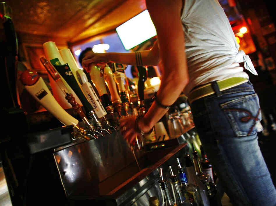 A bartender pours a beer at the Nomad Pub in Milwaukee, Wisc., in 2006.
