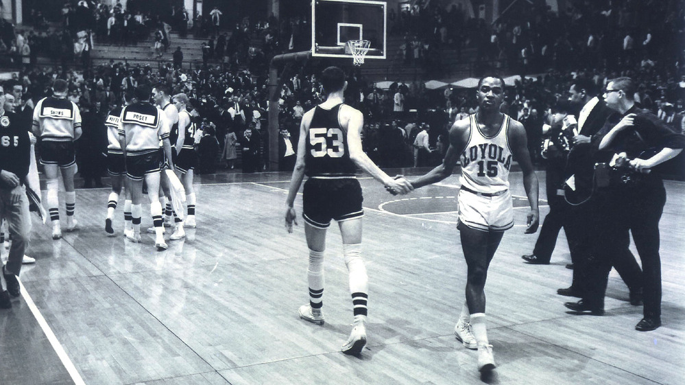 Mississippi State's Stan Brinker (53) and Loyola's Jerry Harkness (15) shake hands before the NCAA Mideast regional semifinal college basketball game in East Lansing, Mich., on March 15, 1963. The game was a landmark contest between the schools that helped alter race relations on the basketball court.