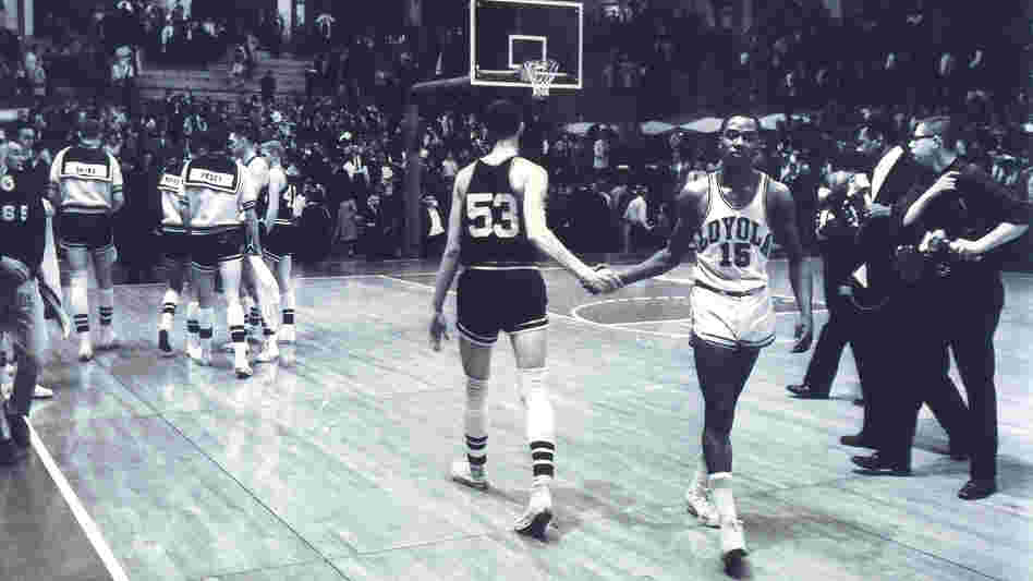 Mississippi State's Stan Brinker (53) and Loyola's Jerry Harkness (15) shake hands before the NCAA Mideast regional semifinal college basketball game in East Lansing, Mich., on March 15, 1963. The game was a landmark contest between the schools that helped alter race relations on the basketball court.