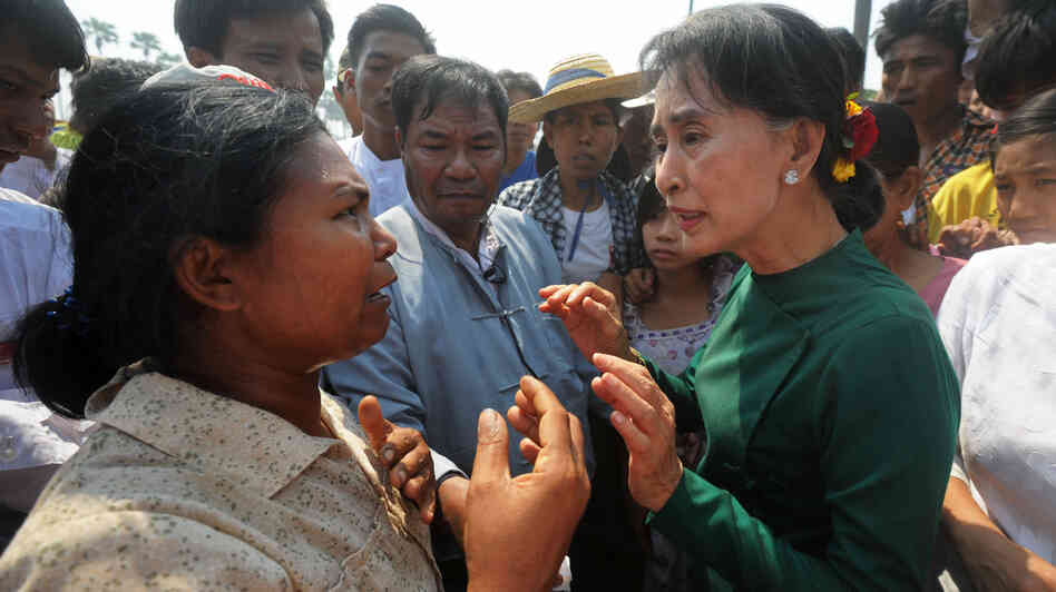 Aung San Suu Kyi (right) faced protesters when she traveled to a village in northern Myanmar on Thursday to discuss a Chinese-backed copper mine project. Suu Kyi, a Nobel laureate and a member of Parliament, urged protesters to support the project, which was the scene of a violent crackdown last year. She said opposing the project would risk hurting the country's economy.