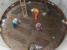Archaeologists examine skeletons thought to be from the 14th century that were discovered in an excavation belonging to British rail company, Crossrail. Archaeologists examine skeletons thought to be from the 14th century that were discovered in an excavation belonging to British rail company, Crossrail.