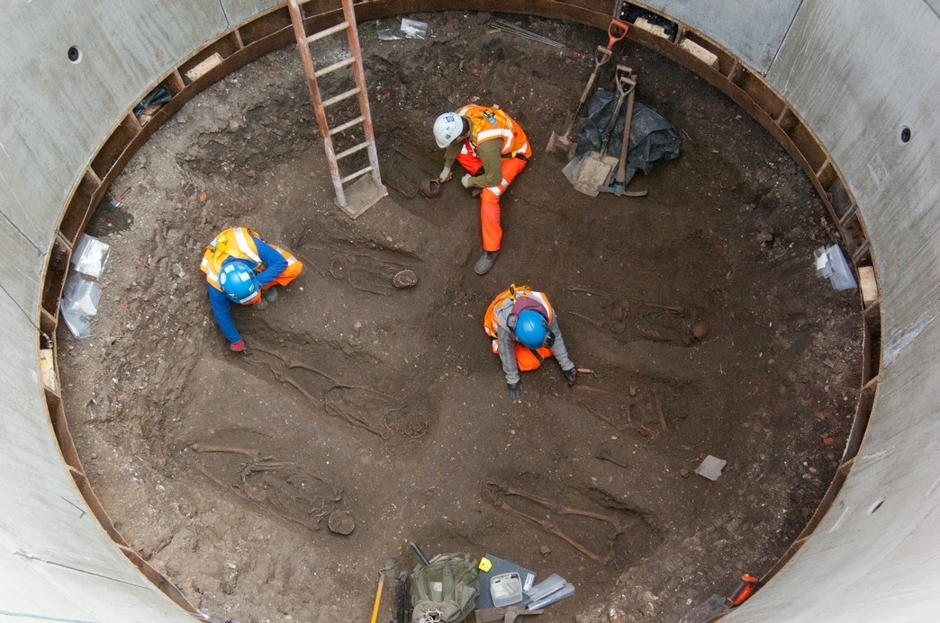 Archaeologists examine skeletons thought to be from the 14th century that were discovered in an excavation belonging to British rail company, Crossrail.