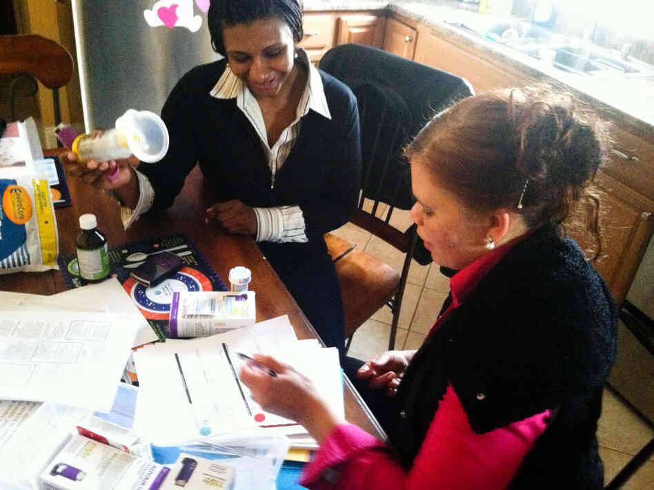 Maria Texeira-Gomes talks with Margie Lorenzi, a community health worker, about the progress they are making with her son's asthma. Maria Texeira-Gomes talks with Margie Lorenzi, a community health worker, about the progress they are making with her son's asthma.