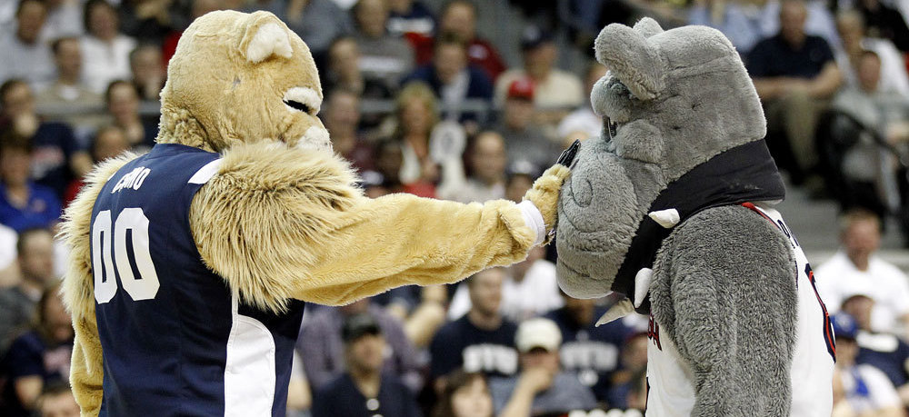Cosmo the Cougar, left, and Spike the Bulldog during a timeout of at an NCAA college basketball game.