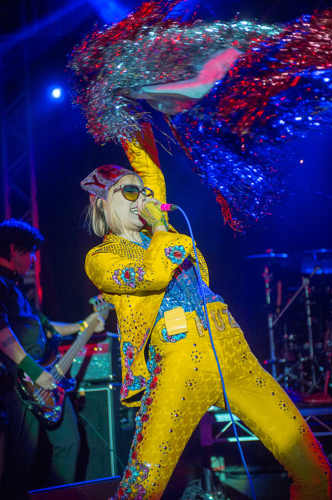 Karen O emerged on stage at Stubb's in Austin clad in canary yellow, sporting a sparkly fez, giant eyeglasses, and a glittering scarf.