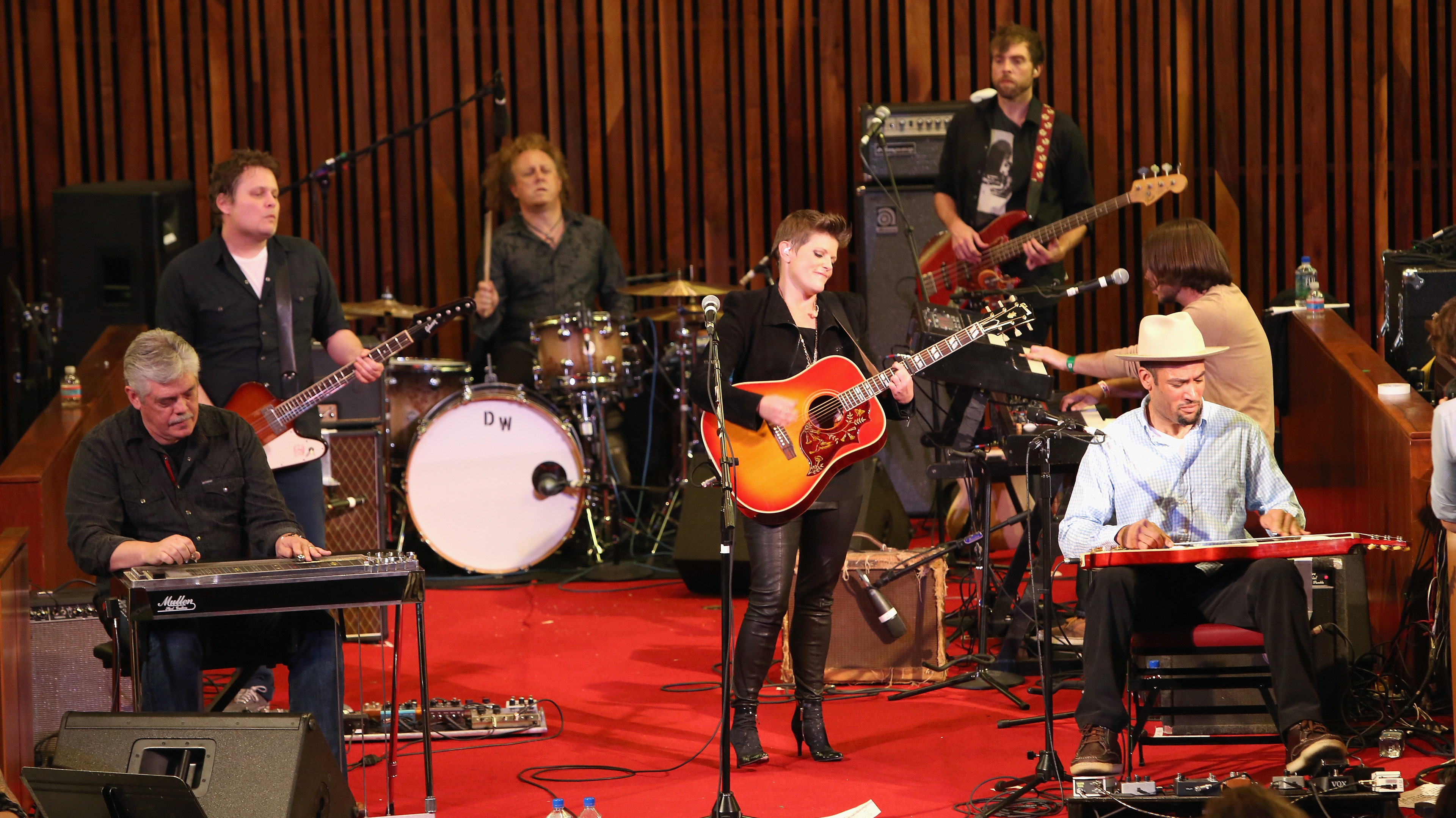 Natalie Maines (center) at Central Presbyterian Church in Austin, Texas during the SXSW Music Festival. Maines's band included her father, Lloyd Maines (seated left) and Ben Harper (seated right).