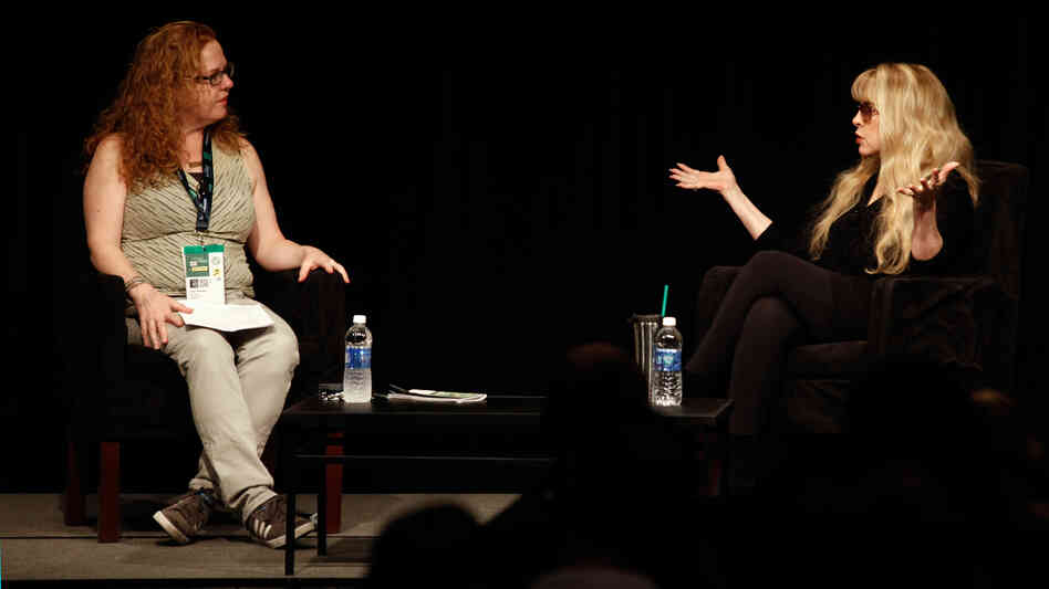 Stevie Nicks (right), speaking in front of a crowd at SXSW in Austin, Texas, told Ann Powers that "a big attitude" was her secret to being taken seriously when she joined Fleetwood Mac.