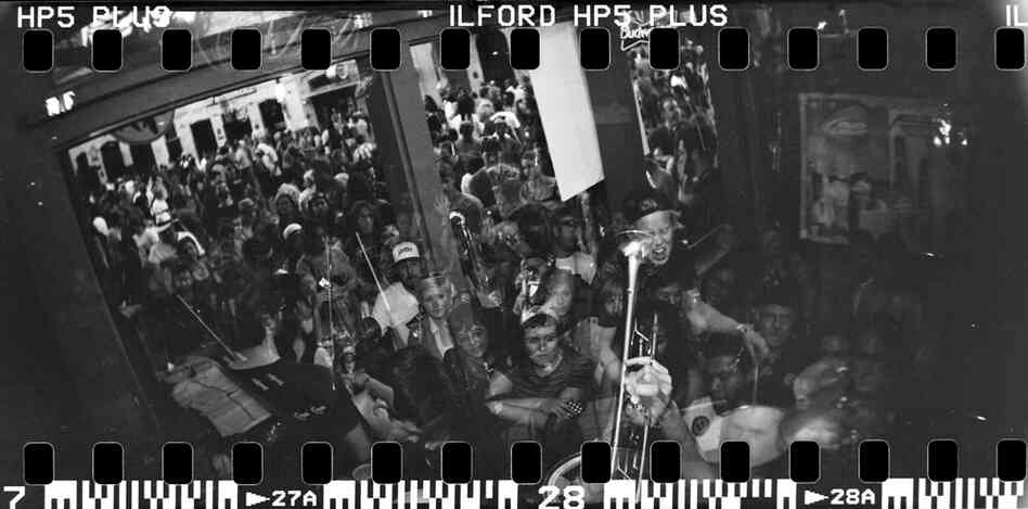 Isaac Winburne, who is considered the most expressive member of the band, plays drums during a five-song set at The Lodge. The stage could only fit half of the band, so the horns and violins stood outside the venue with microphones leading into the sound system. Isaac Winburne, who is considered the most expressive member of the band, plays drums during a five-song set at The Lodge. The stage could only fit half of the band, so the horns and violins stood outside the venue with microphones leading into the sound system.