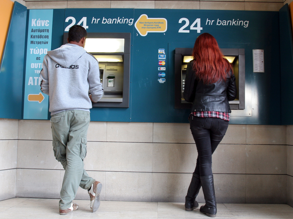 Take the money and run: An ATM in the Cypriot capital Nicosia on Sunday.