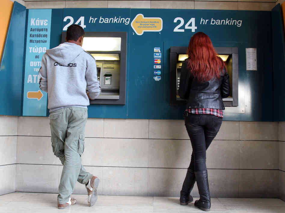 Take the money and run: An ATM in the Cypriot capital Nicosia on Sunday.